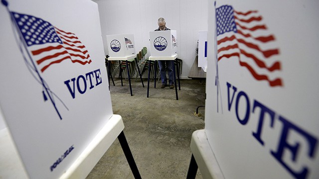 Bow Stanley, From Silver Lake, Kan, Votes At The Prairie Home Cemetery Building, Tuesday, Nov. 4, 2014, In Topeka, Kan. (AP Photo/Charlie Riedel)