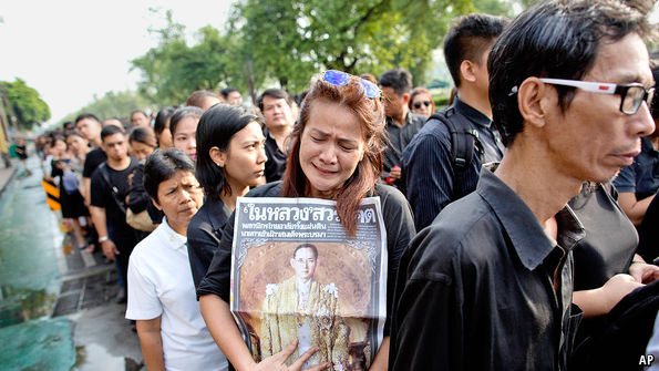 Woman Crying Over A Picture Of The Dead King